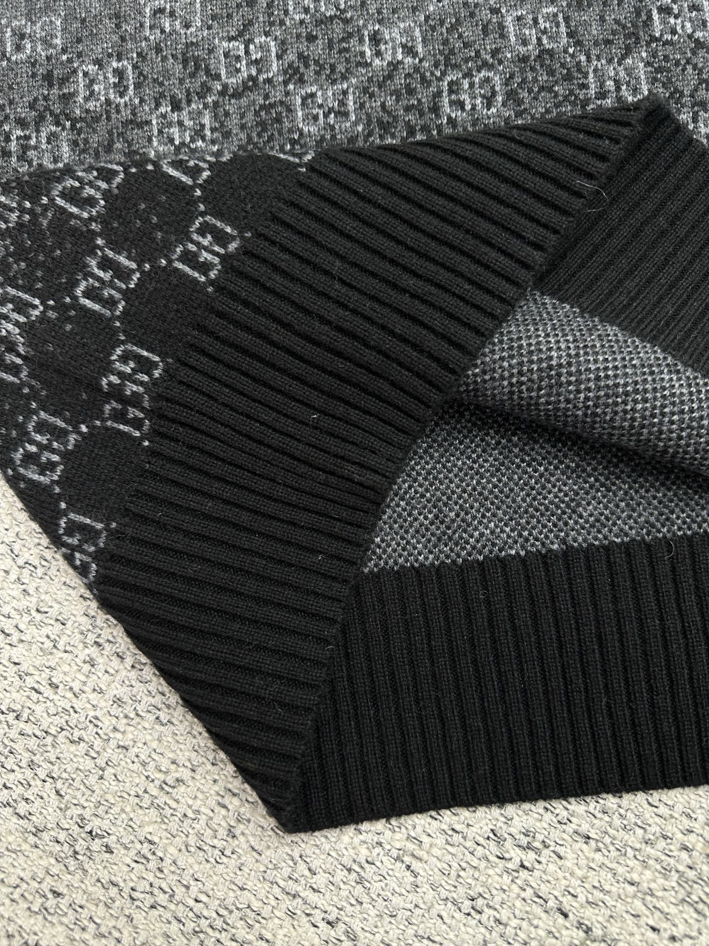 Gucci knit sweater fold showing dark gray GG pattern and ribbed sleeve cuff