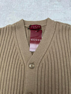 Beige rib-knit V-neck cardigan with four-button front and Gucci label at neck