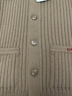 Beige cardigan front panel with three visible buttons and ribbed knit