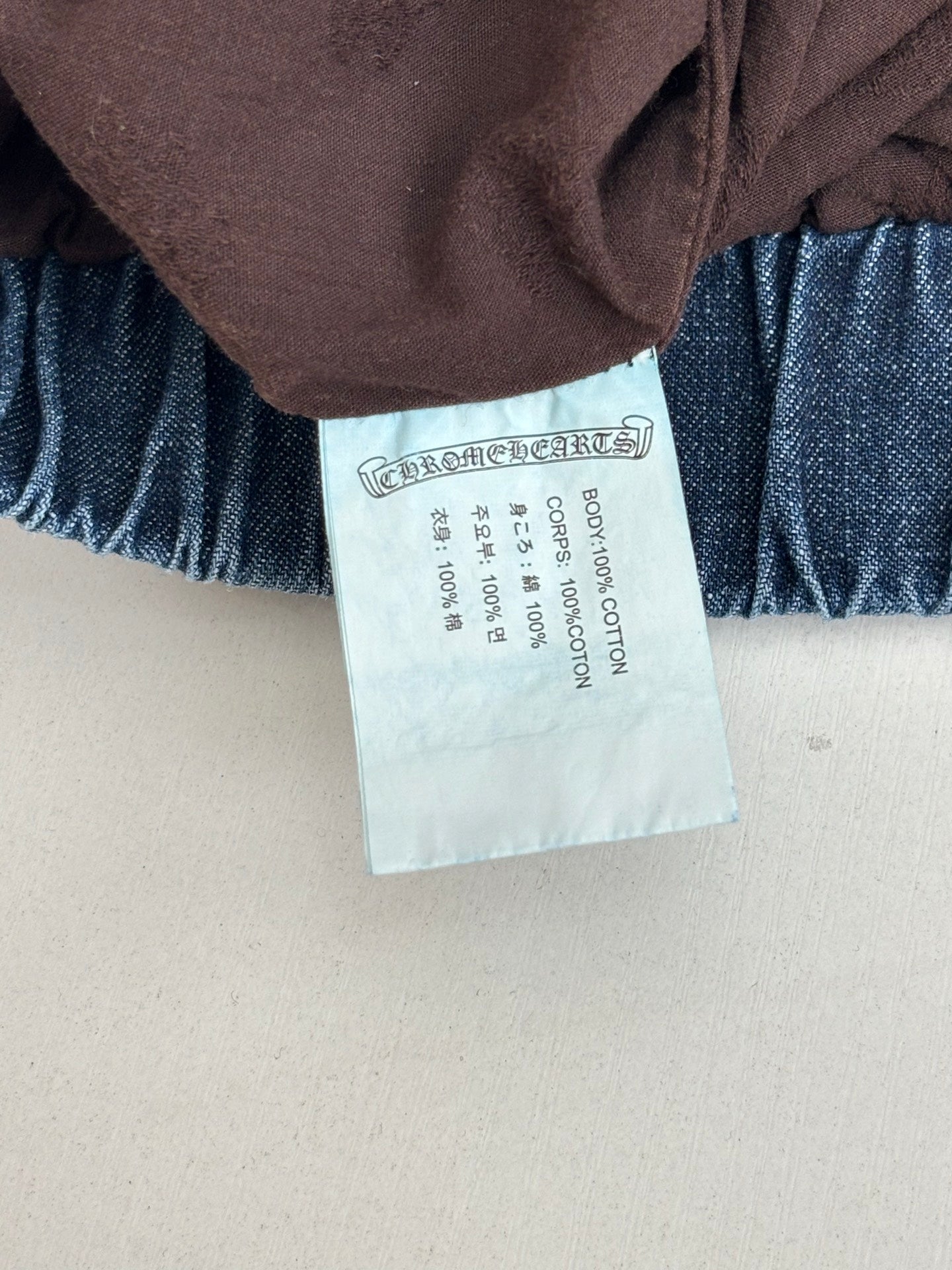 Clothing size tag on blue denim pants waistband