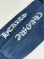Blue denim long pants with white graphic lettering on one leg