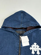 Blue denim hooded jacket with half-zip, white emblem patch, and metal zipper pull.