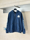 Denim hooded jacket in blue with half-zip front and white embroidered emblem on chest.