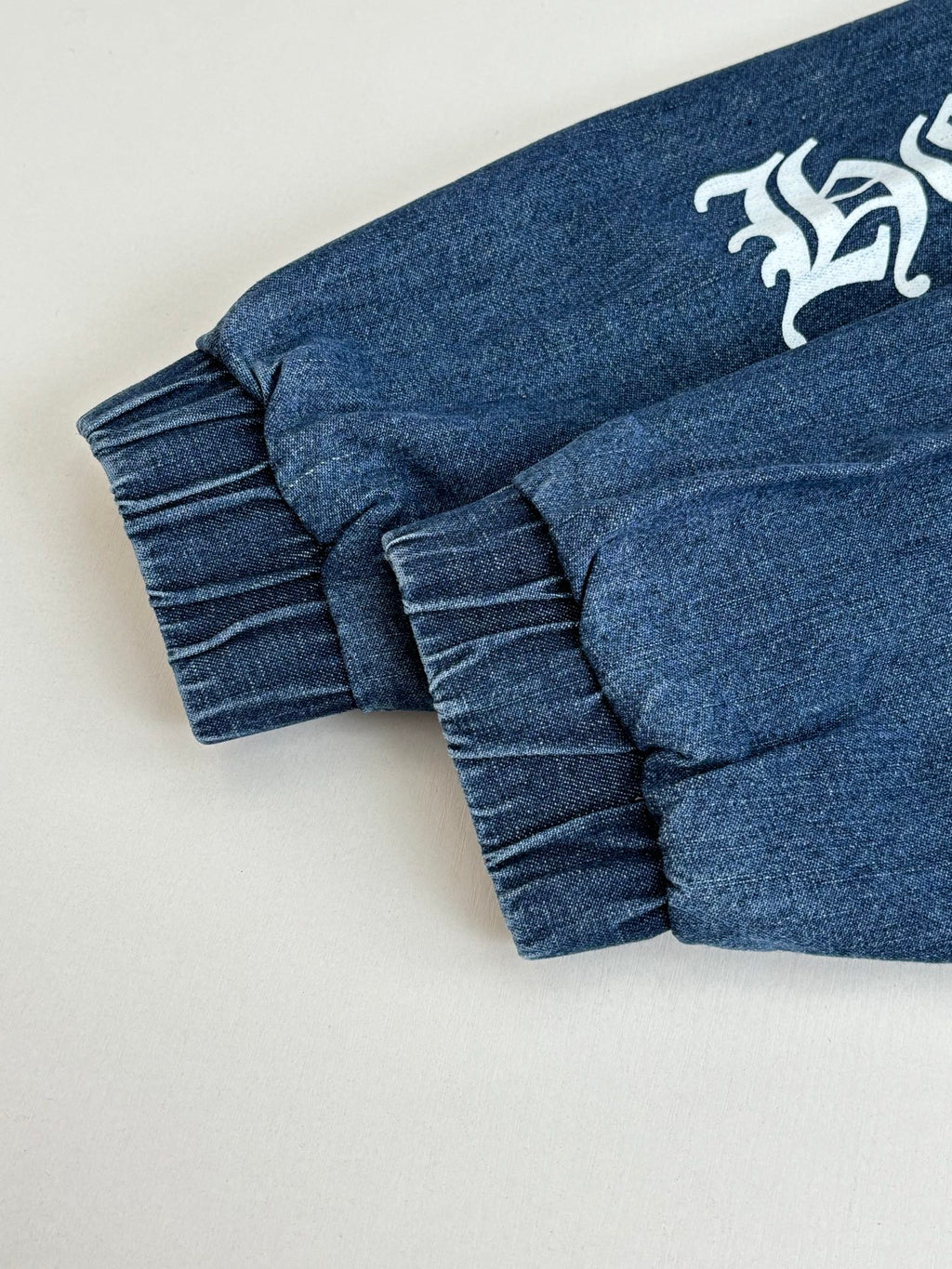 Blue denim long pants with ribbed cuffs and gathered waistband