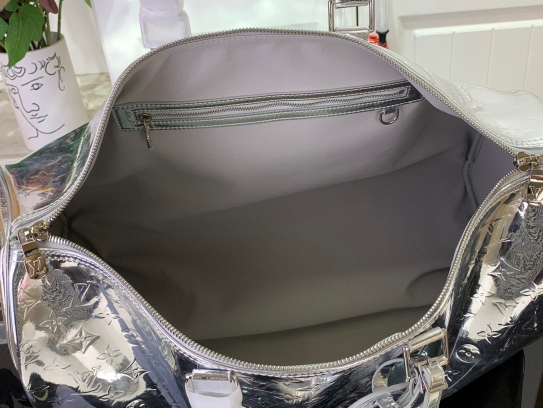 Louis Vuitton metallic silver duffel bag interior with zip pocket and fabric lining