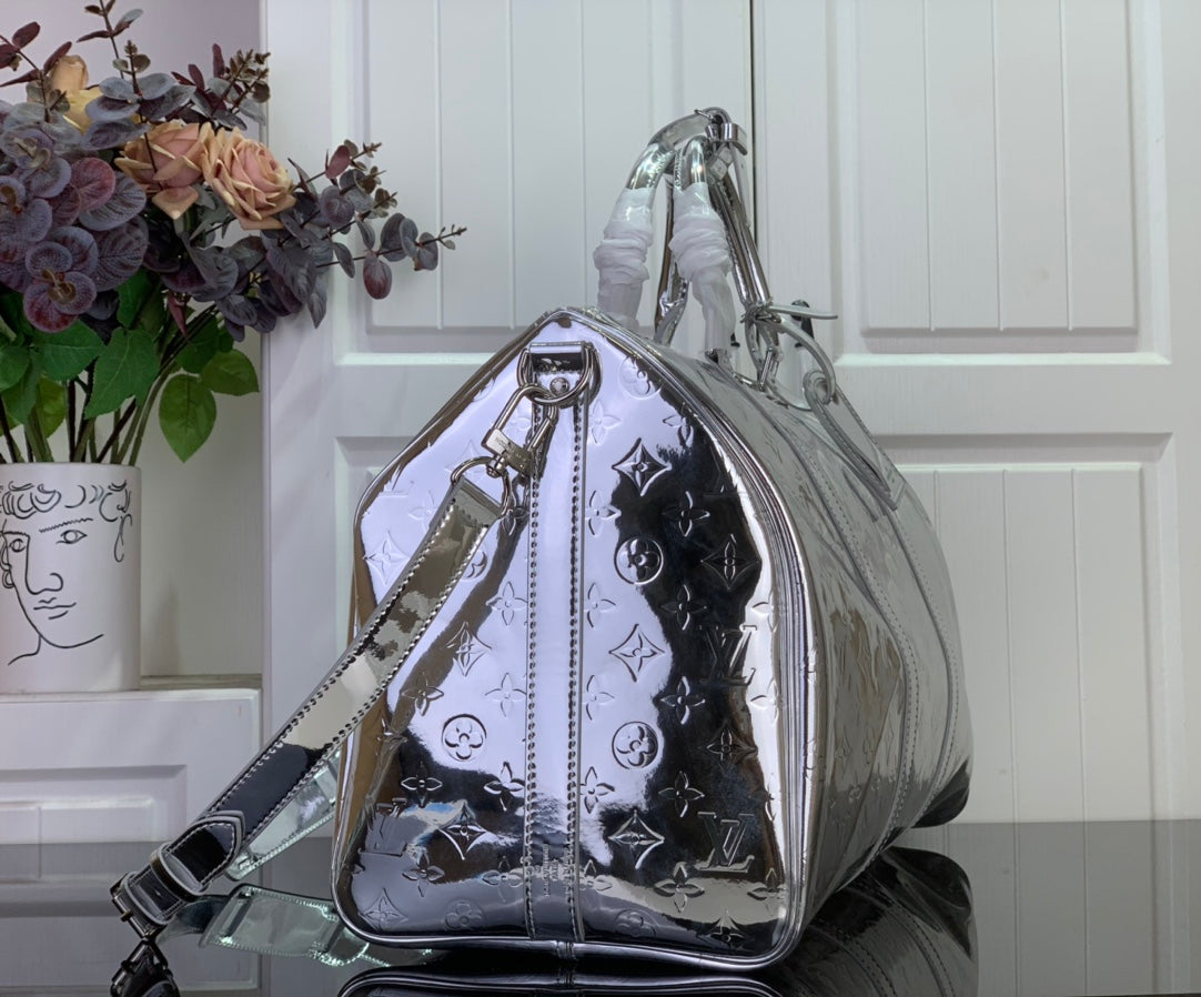 Louis Vuitton metallic silver monogram satchel-style duffel with top handle and strap