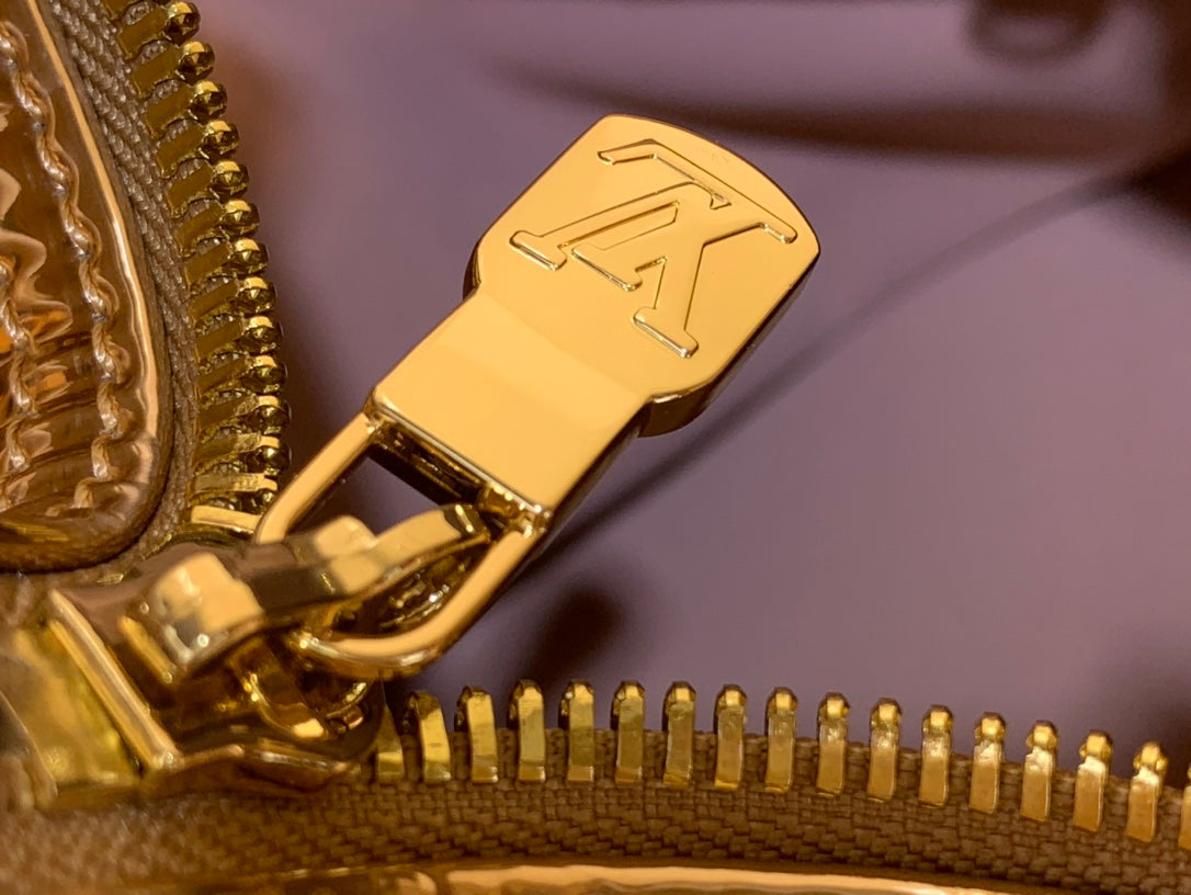 Gold duffel bag zipper pull with logo detail and tightly closed teeth