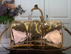 Gold monogram duffel bag with top handles and shoulder strap, shiny finish