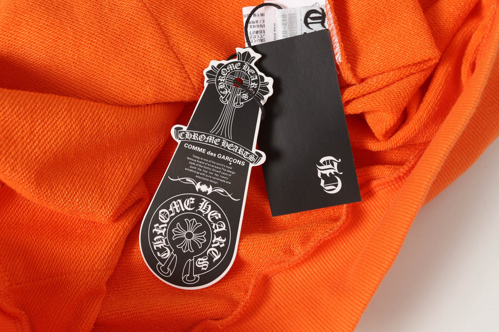 Orange long-sleeve shirt with hanging tags and label strings