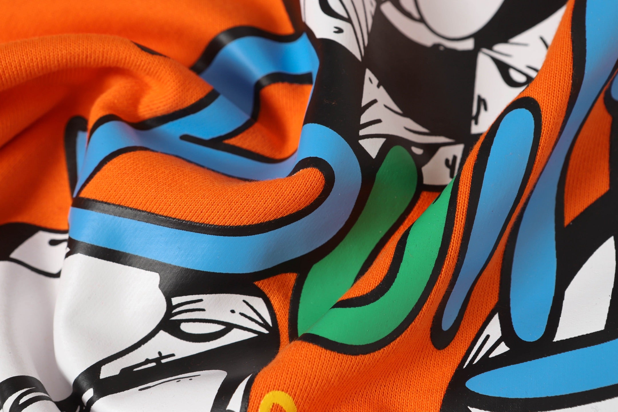 Orange long-sleeve shirt with colorful graffiti-style graphic print