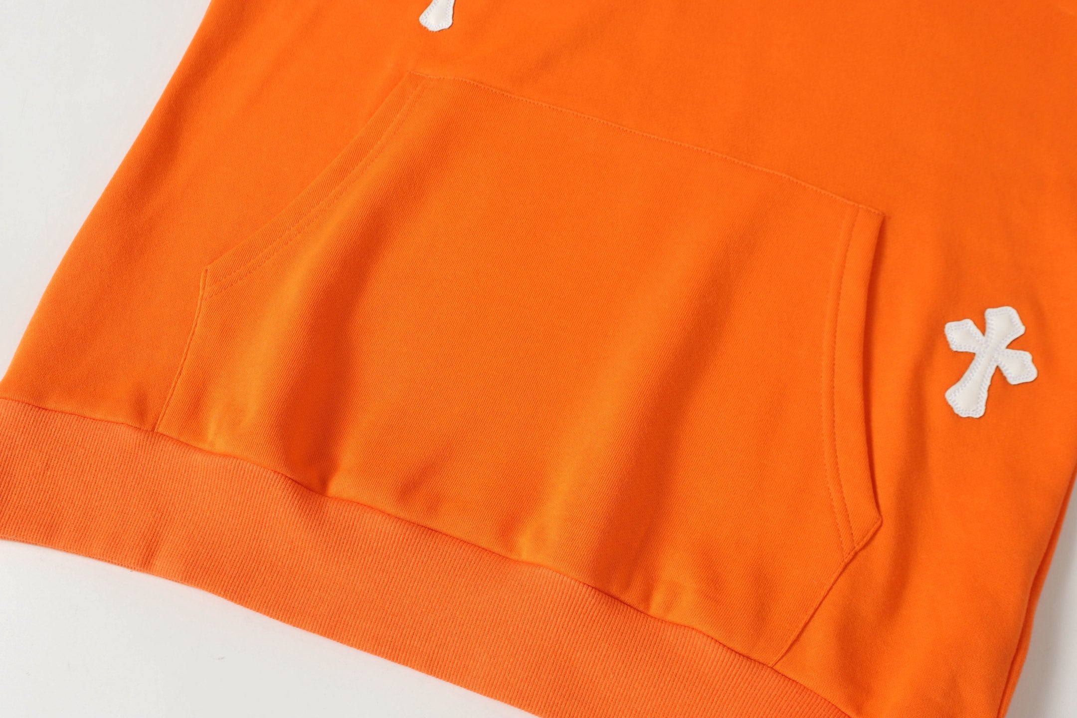 Orange long-sleeve shirt with chest pocket and small side logo detail