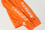Orange hoodie sleeve with white decorative lettering graphic