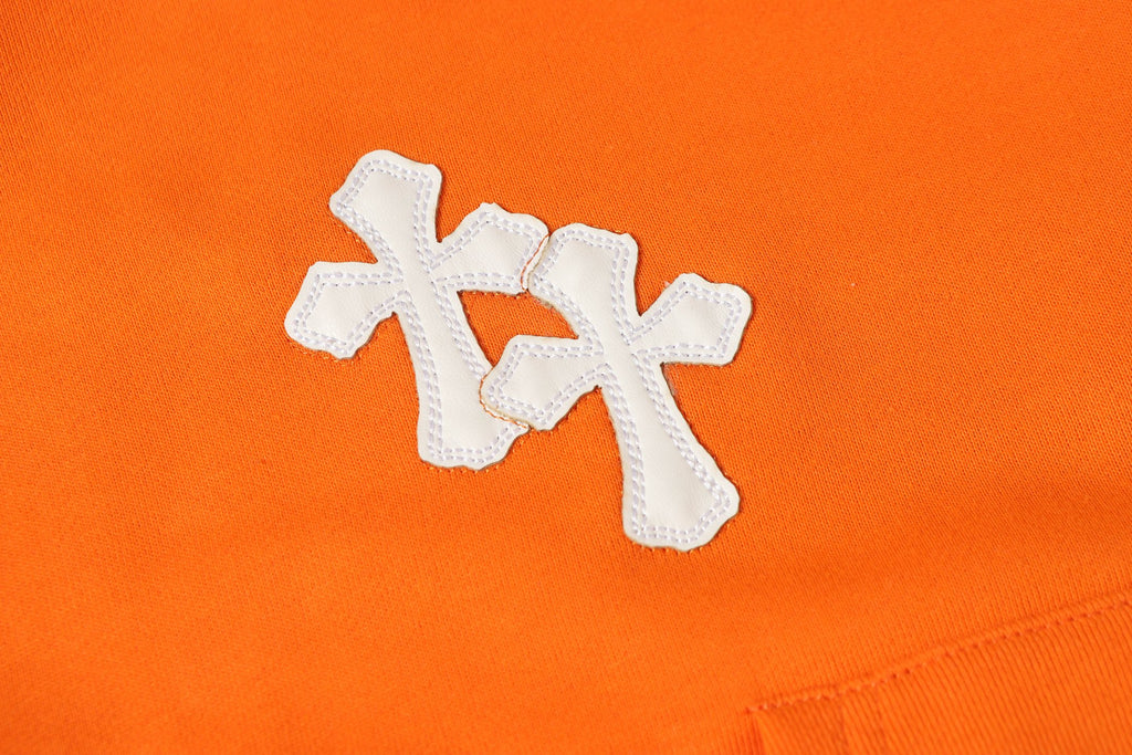 Orange hoodie front with white stitched cross applique