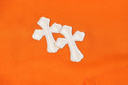 Orange hoodie front with white stitched cross applique