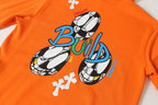 Orange hoodie front with large “Build” character graphic