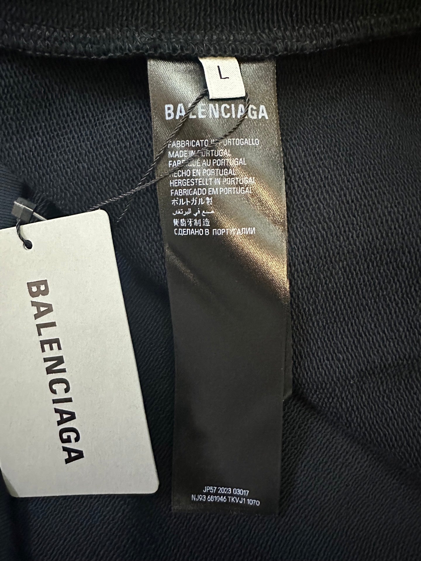 Balenciaga size L fabric care label on dark sweatshirt