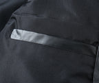 Black puffer jacket inner pocket with white checkered fabric tab