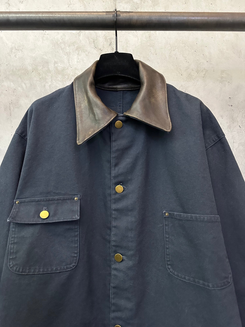 Navy long jacket with beige contrast point collar, button front, and flap chest pockets