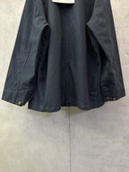 Navy long jacket interior view with pocket opening and buttoned cuffs