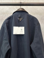 Navy long jacket back with hang tag and central neckline seam detail