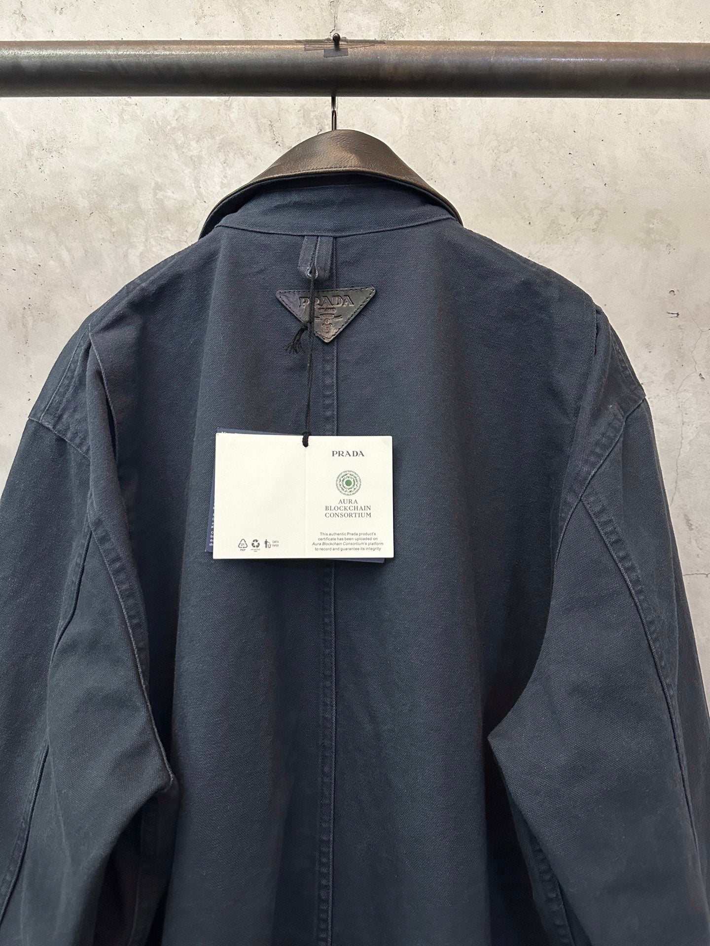 Navy long jacket back with hang tag and central neckline seam detail