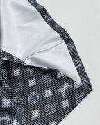 Long-sleeve top close-up of shoulder seam and contrast white trim with dark print