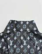 Long-sleeve top collar area with dark geometric pattern and wide neckline band
