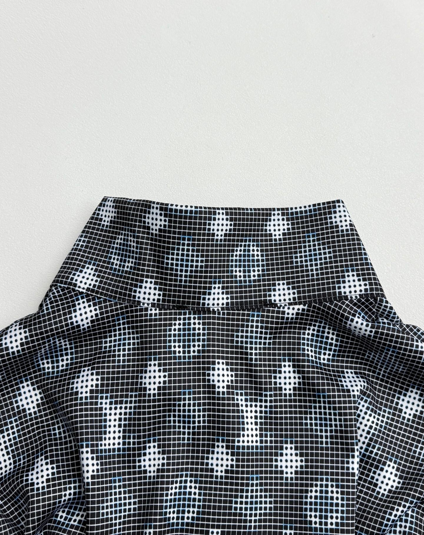 Long-sleeve top collar area with dark geometric pattern and wide neckline band