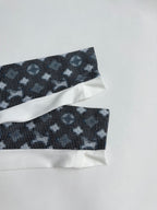 Long-sleeve top sleeve cuffs with white bands and dark geometric pattern