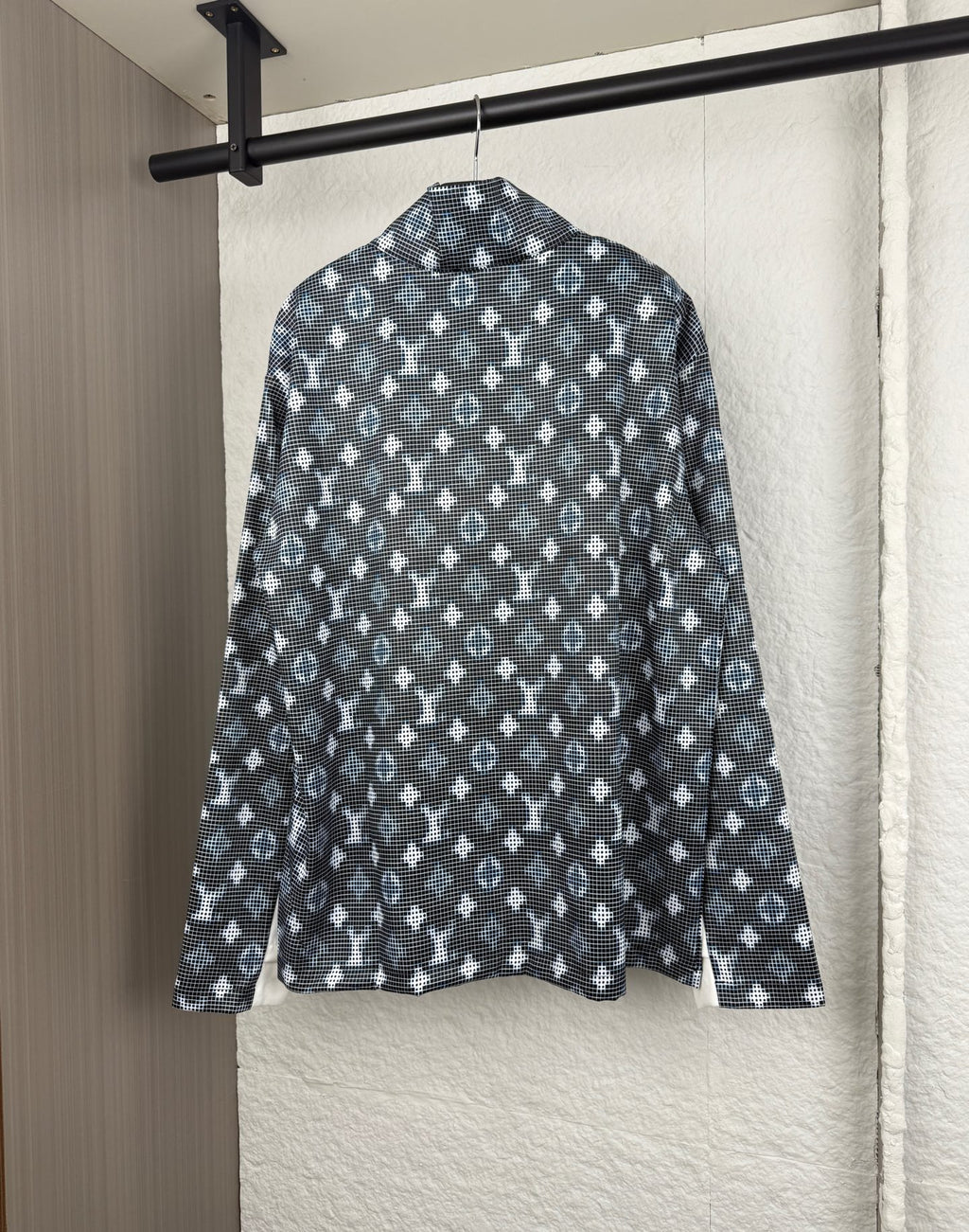 Long-sleeve top back view with dark geometric pattern and standing collar