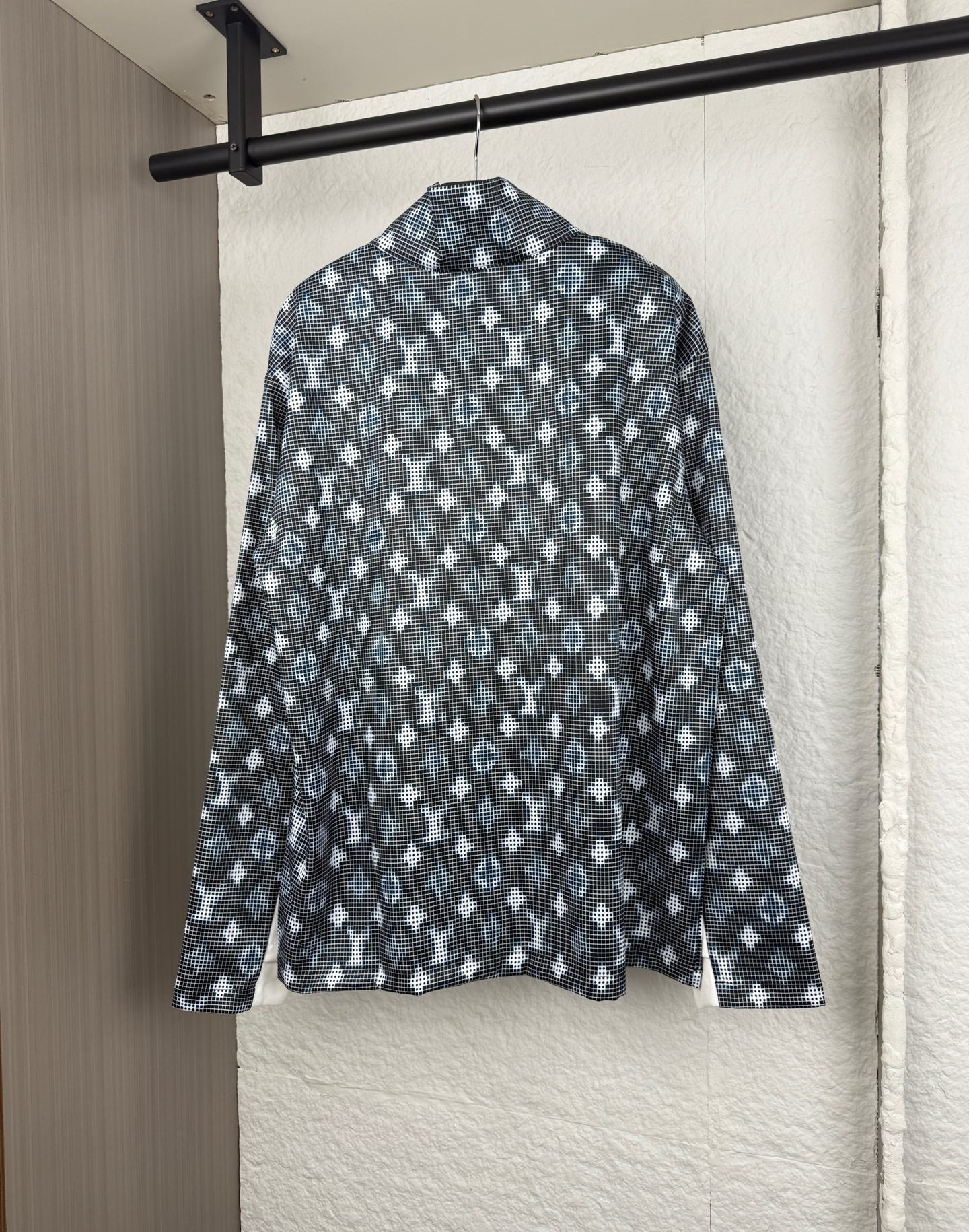 Long-sleeve top back view with dark geometric pattern and standing collar