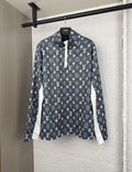 Long-sleeve top with dark geometric pattern, half-zip placket, and standing collar