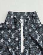 Long-sleeve top neckline detail with dark geometric print and central zip placket