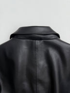Black leather-look jacket with structured shoulder yoke and back collar