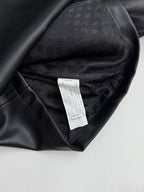 Black leather-look jacket interior with care label and inner lining