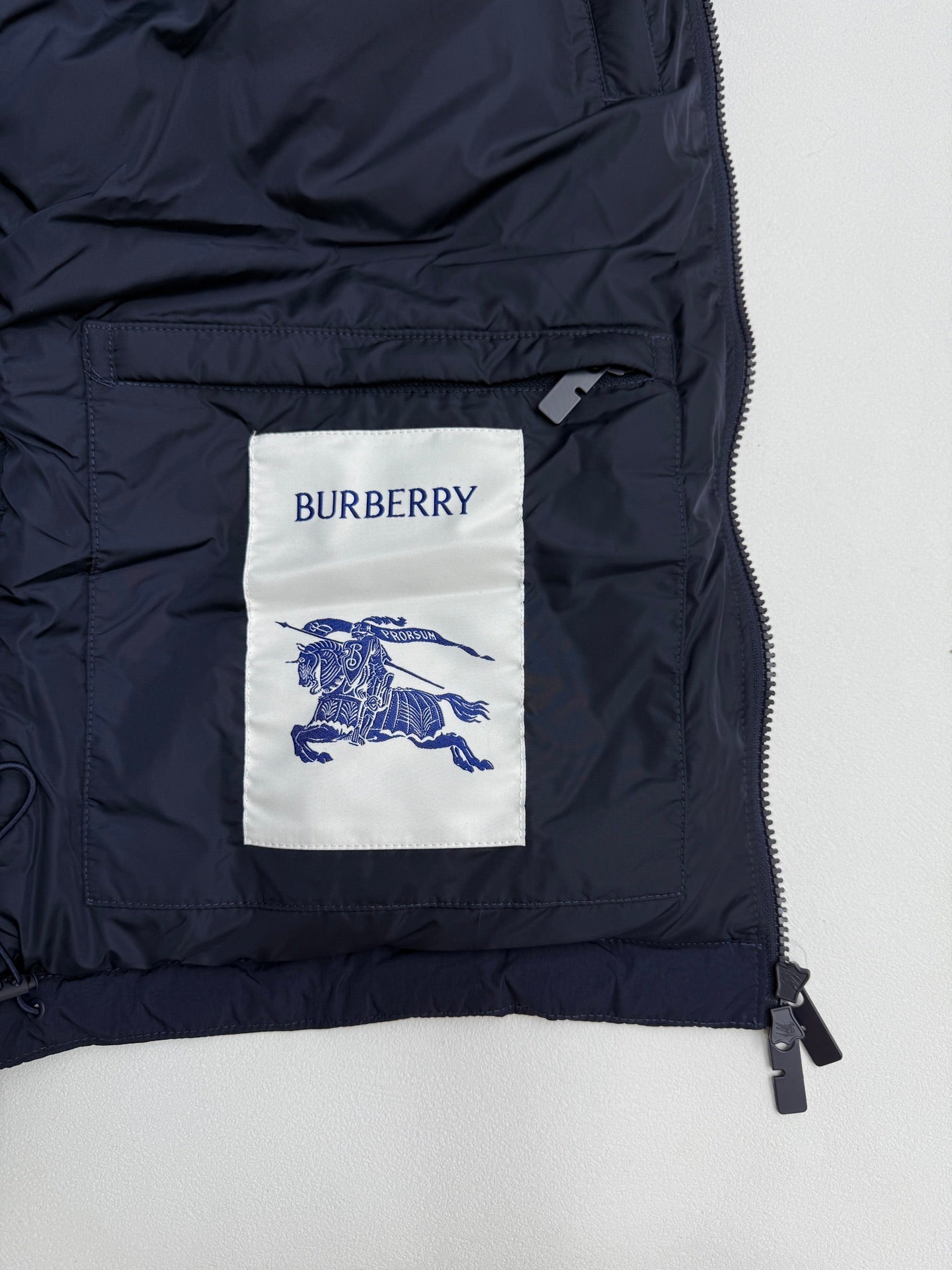 Burberry navy puffer jacket interior pocket lining with brand label and zipper