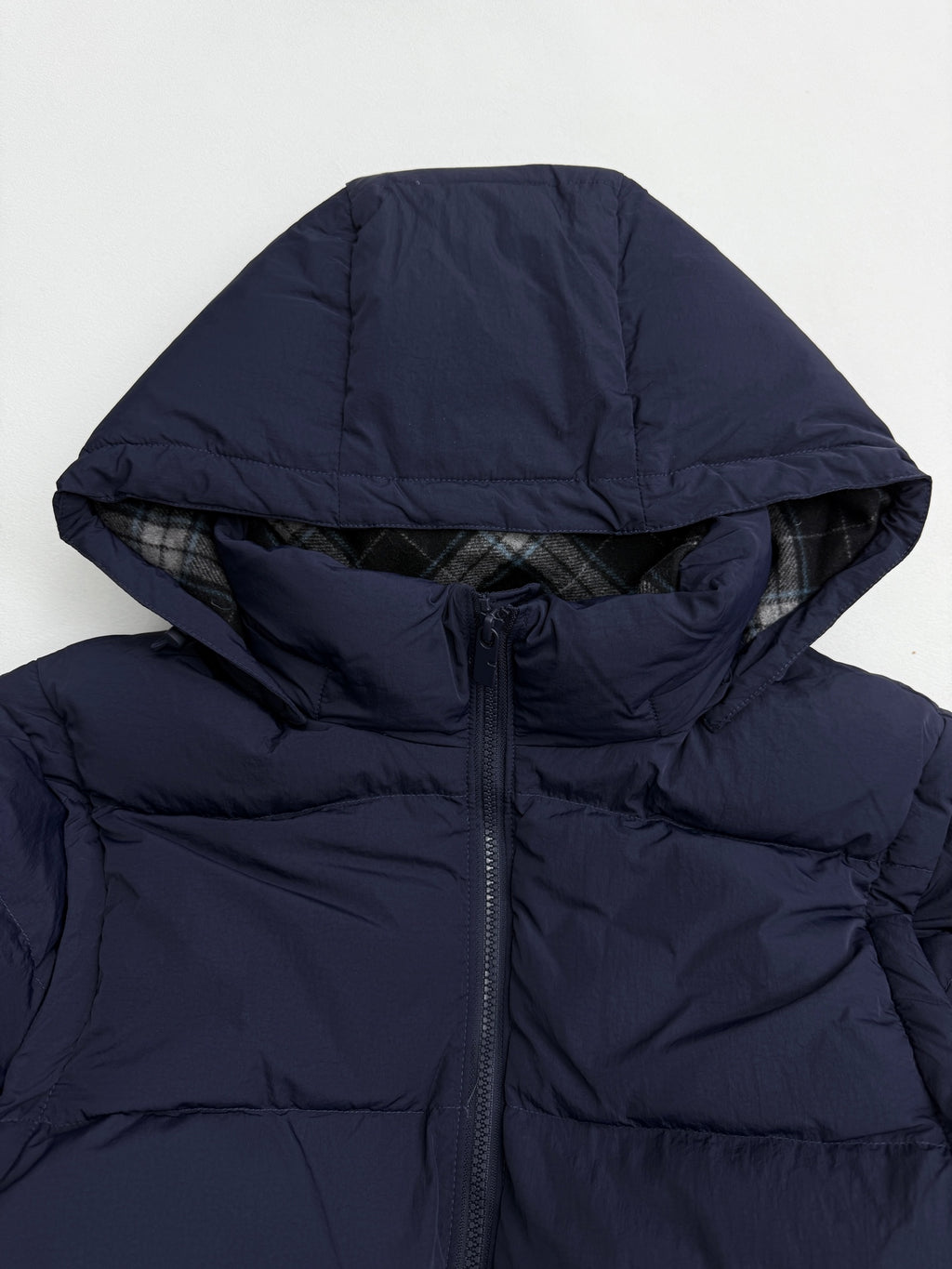 Navy quilted puffer hood with front zipper and dark drawstring
