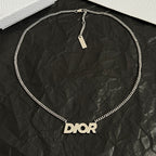 Dior necklace with silver chain and Dior logo pendant on round loop