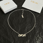Dior necklace with silver chain, small tag, and Dior logo pendant