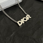 Dior necklace with gold chain and large Dior logo pendant