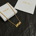 Gold-tone Dior necklace with Dior pendant on a curb chain.