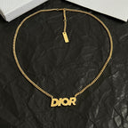 Gold-tone Dior necklace with Dior pendant and rectangular ID tag.