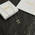 Dior bow necklace, silver-tone chain with rhinestone bow and letter D pendant