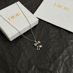 Dior bow necklace, silver-tone chain with rhinestone bow and letter D pendant