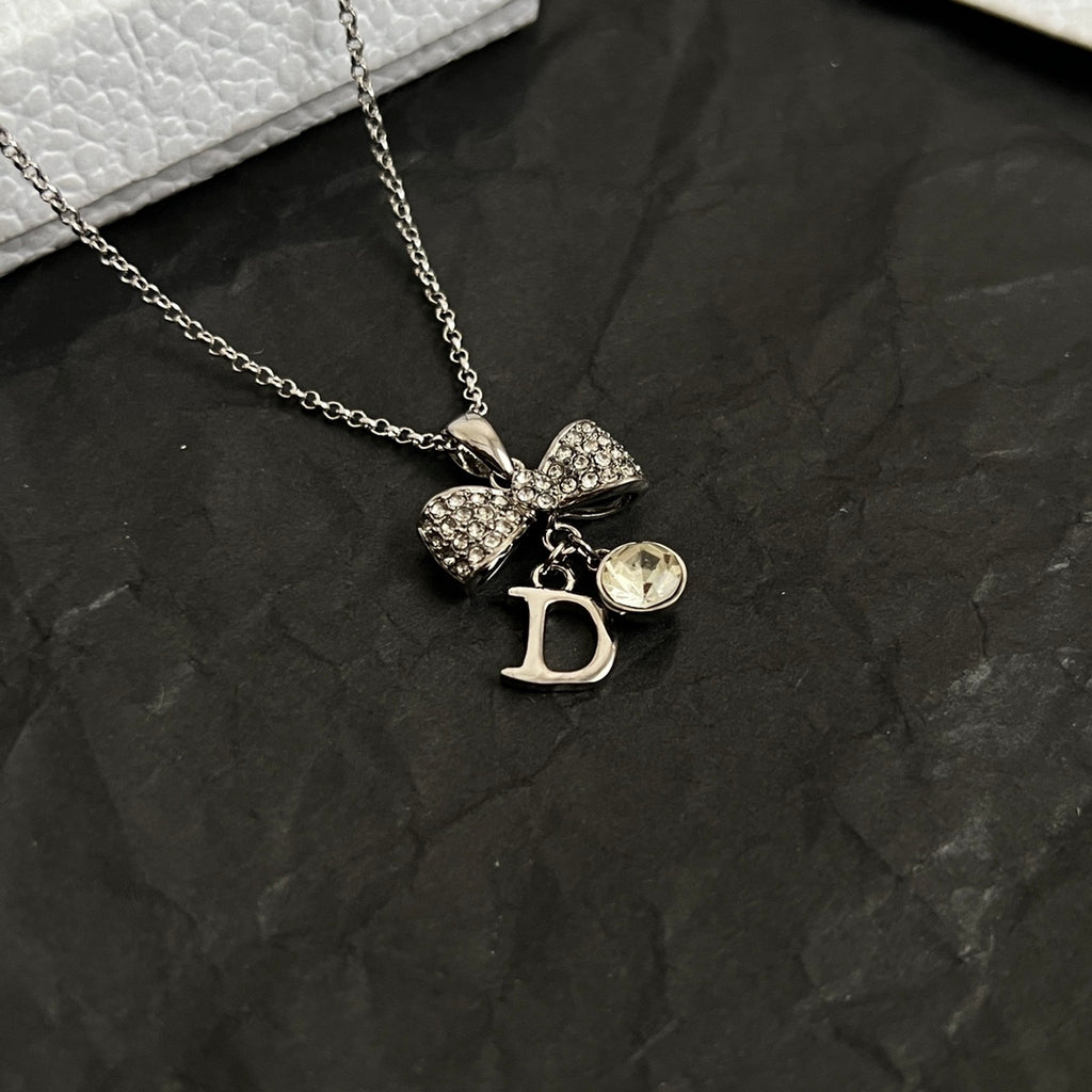 Dior bow necklace, silver-tone chain with rhinestone bow and D drop charm