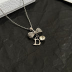 Dior bow necklace, silver-tone chain with rhinestone bow and D drop charm