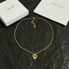 Dior gold-tone collar necklace with heart pendant and small logo charm