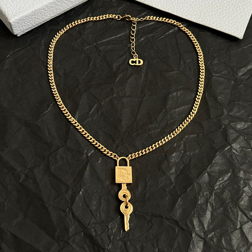Dior gold-tone heart-link chain necklace with lock tag and key drop