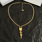 Dior gold-tone heart-link chain necklace with lock tag and key drop