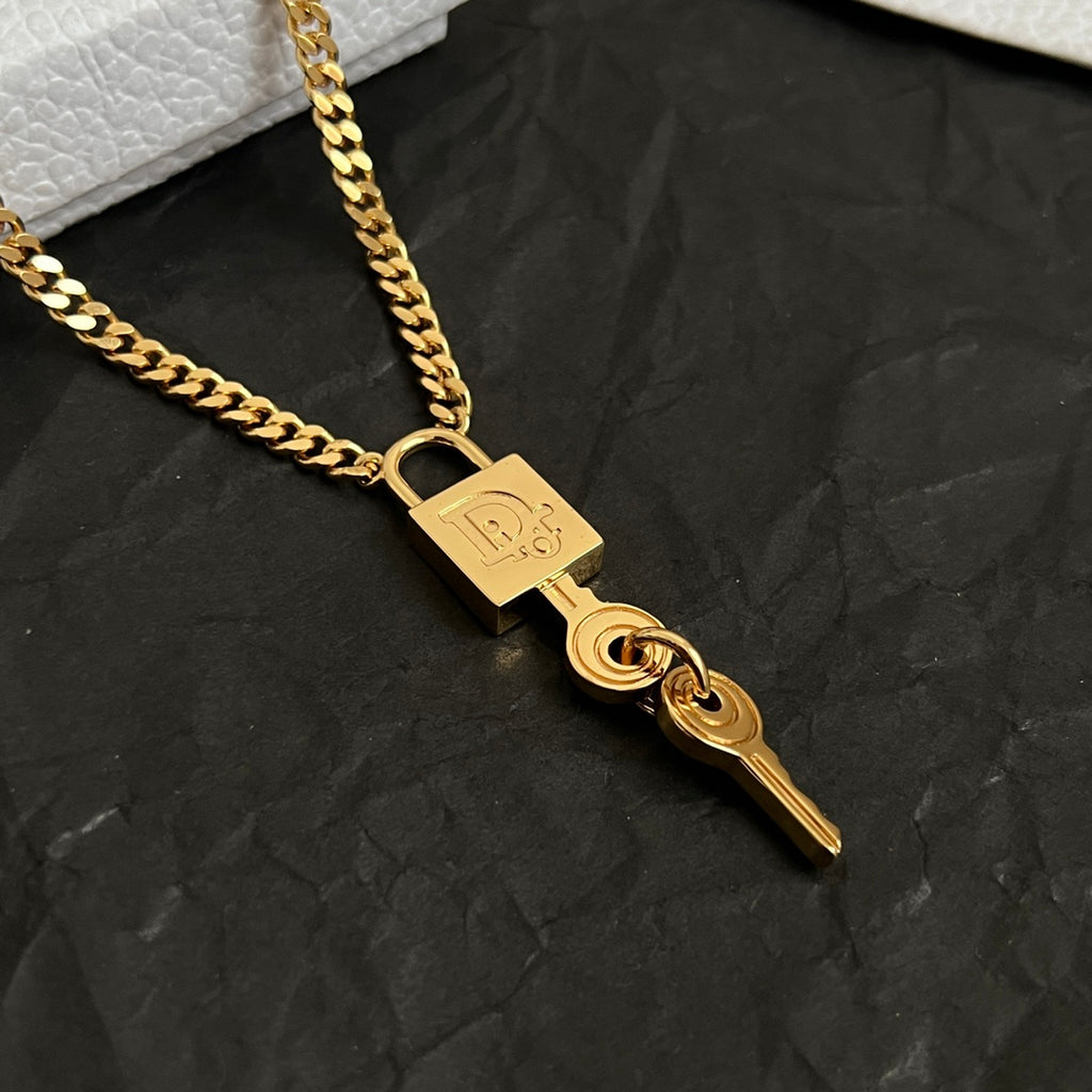 Dior gold-tone key charm necklace with engraved padlock tag on link chain